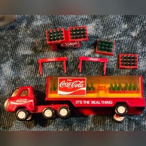 This is a vintage Buddy L Coca-Cola delivery truck with Mini Bottles